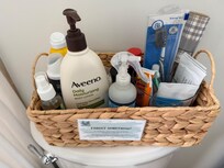 Basket in bathroom with items “you may have forgotten to pack”