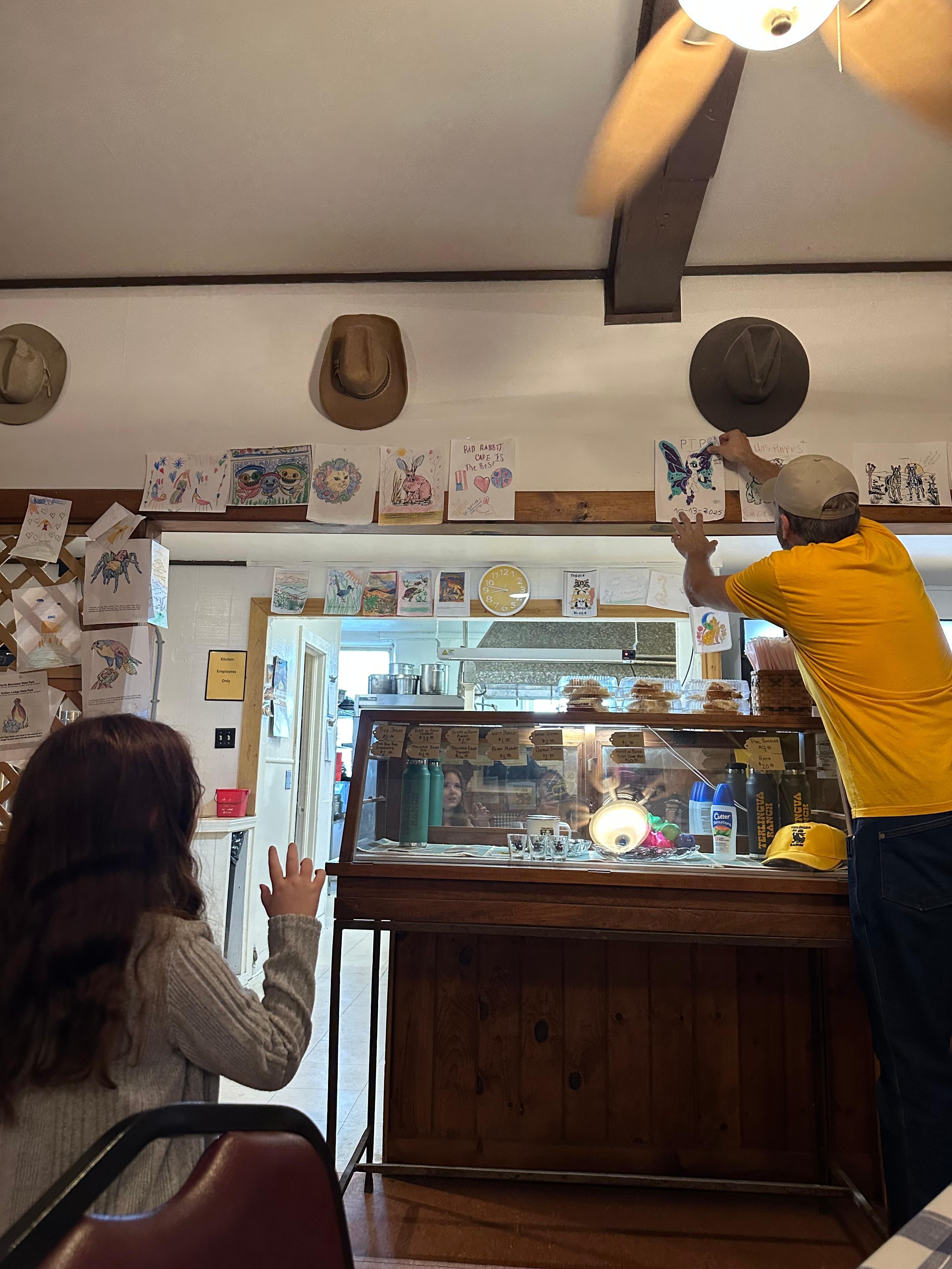 Staff hanging my daughter’s art.
