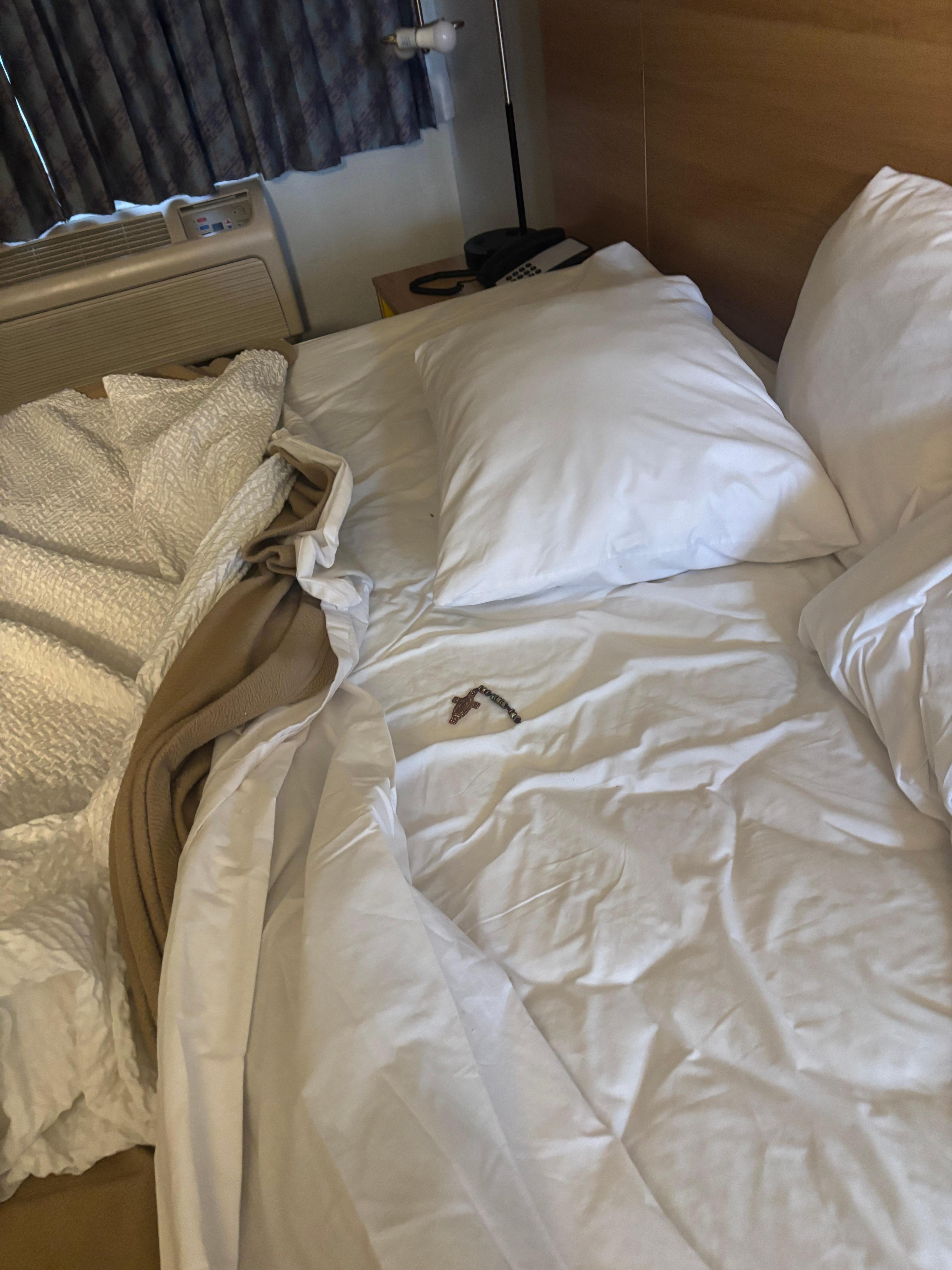 Broken necklace in bed