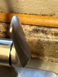 Mold around the kitchen sink trim.