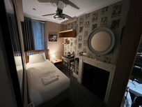 Don't be fooled by the wide angle lens. The room is not as large as it appears. But that said, it didn't trigger my claustrophobia at all... perhaps the mirror over the fireplace... or the place's personality. It was a great place to stay.