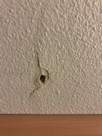 Hole in the wall from the door