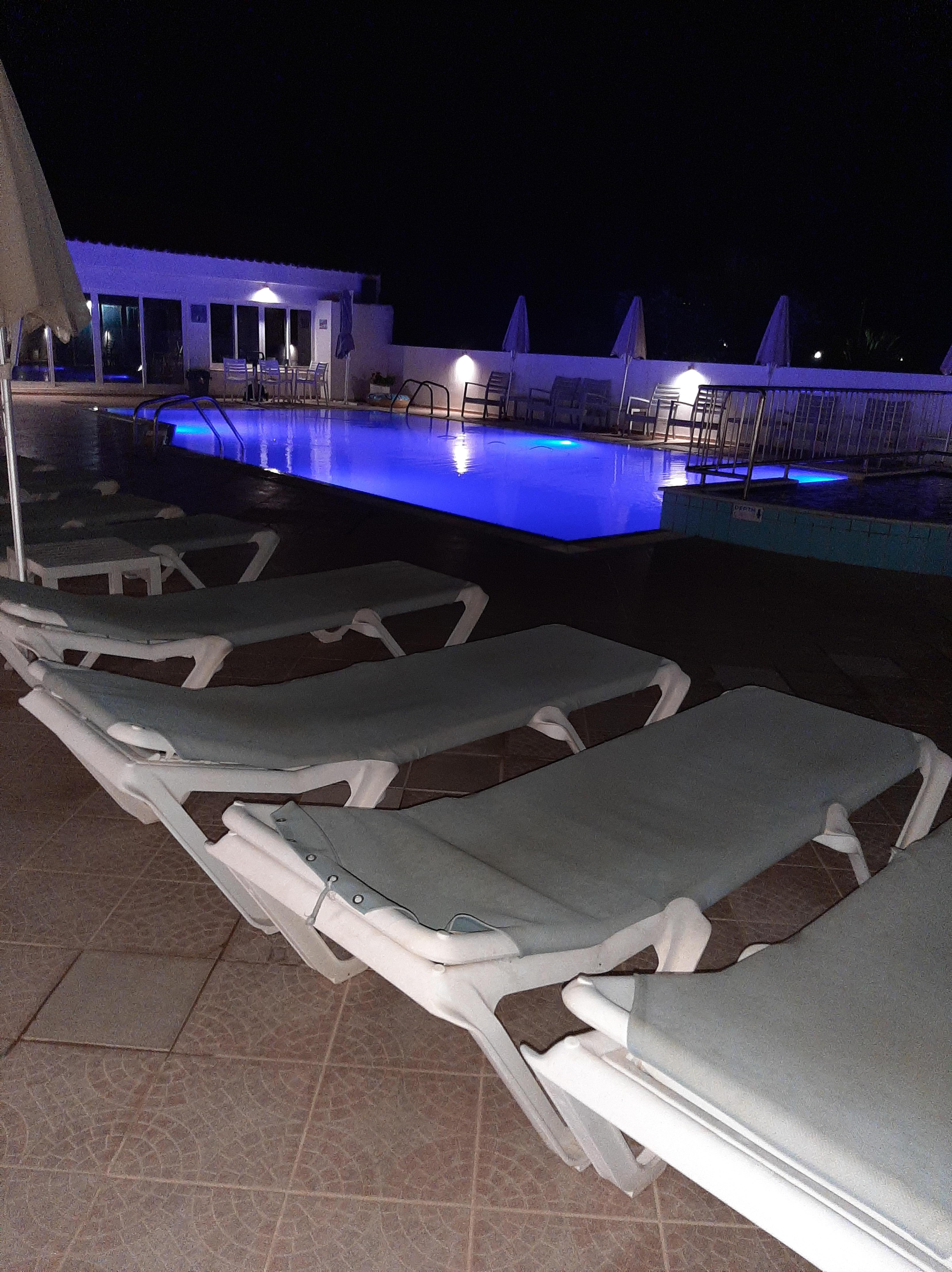 Pool at night, clean and well maintained.