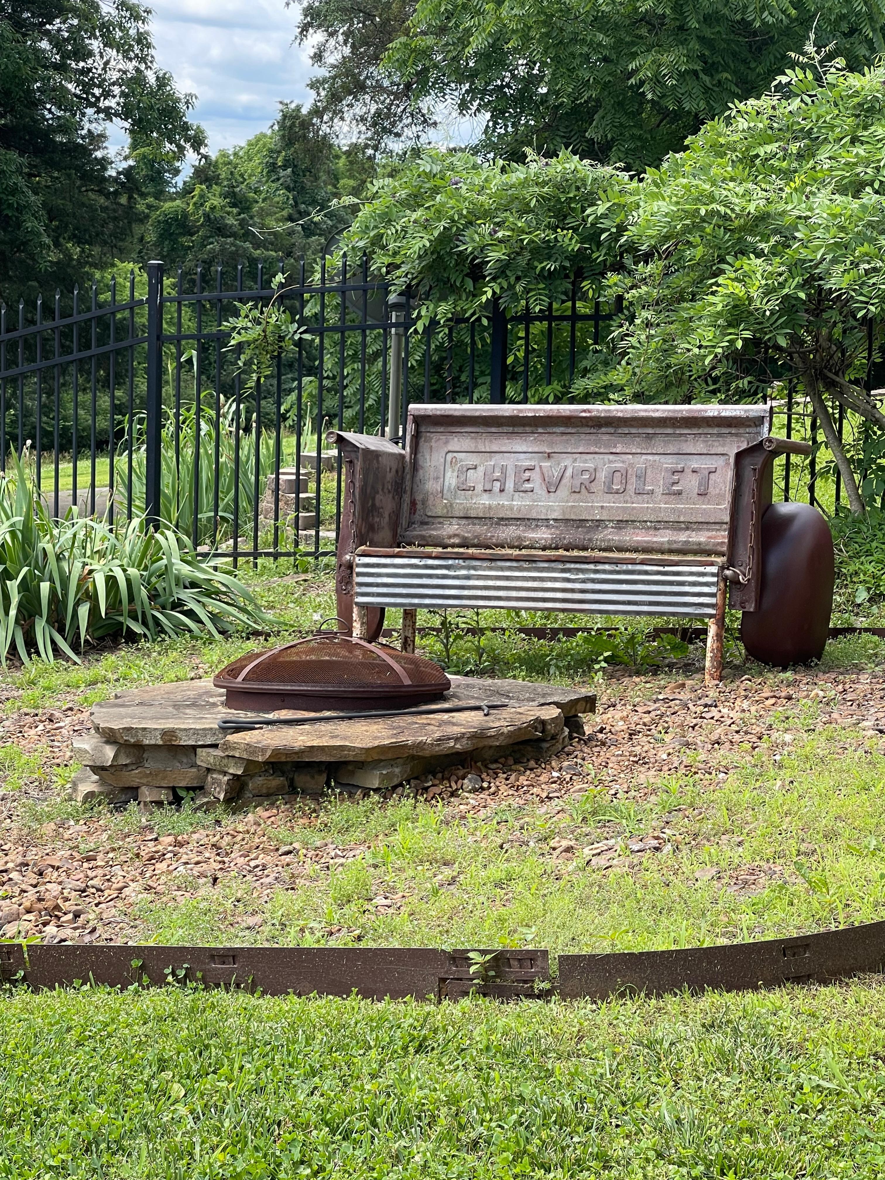 Fire pit and a vintage bench made from old car parts.