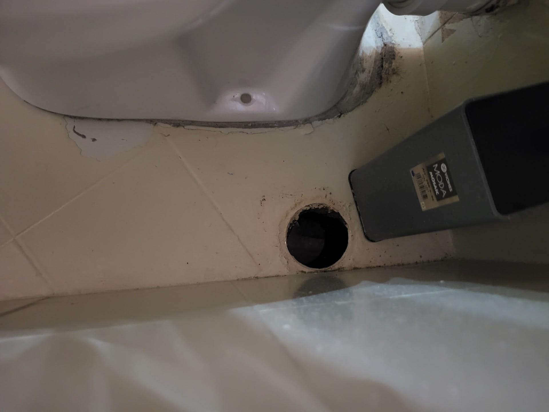 Hole in floor with water bubbling at the top.