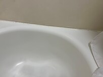 The grout in the back of the tub