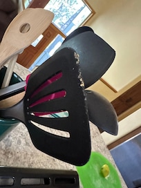 Food stuck on spatula by stove