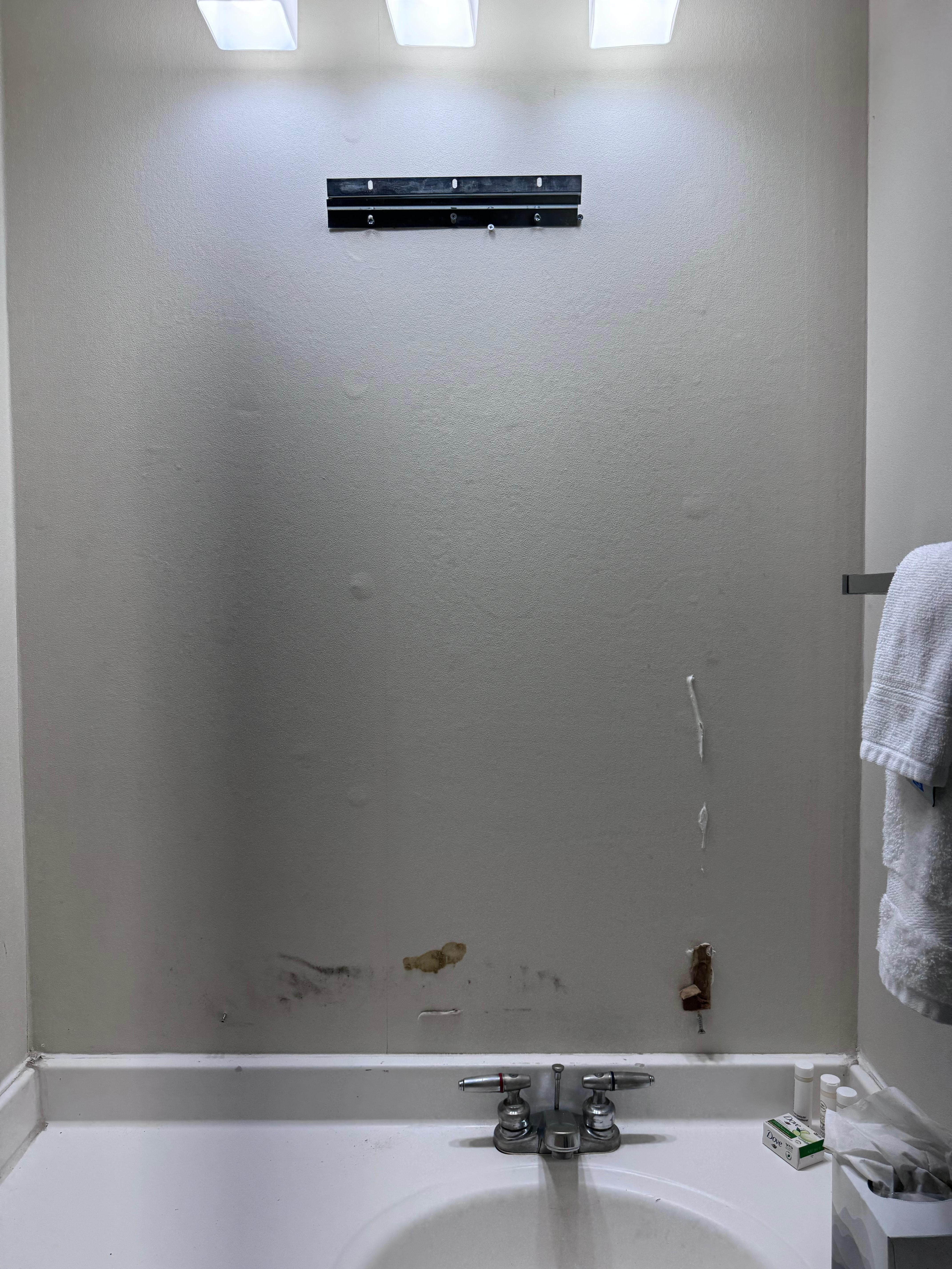Mirror off wall, hardware sticking out of wall