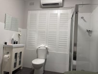 Washhand basin, shower and loo in the room