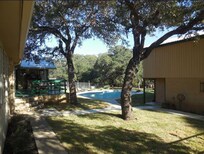 This a a Photo of the pool.  Note what looks like a hand rail on the steps from the deck which are now missing.  All those beautiful oak trees died of oak wilt and are being dug out.