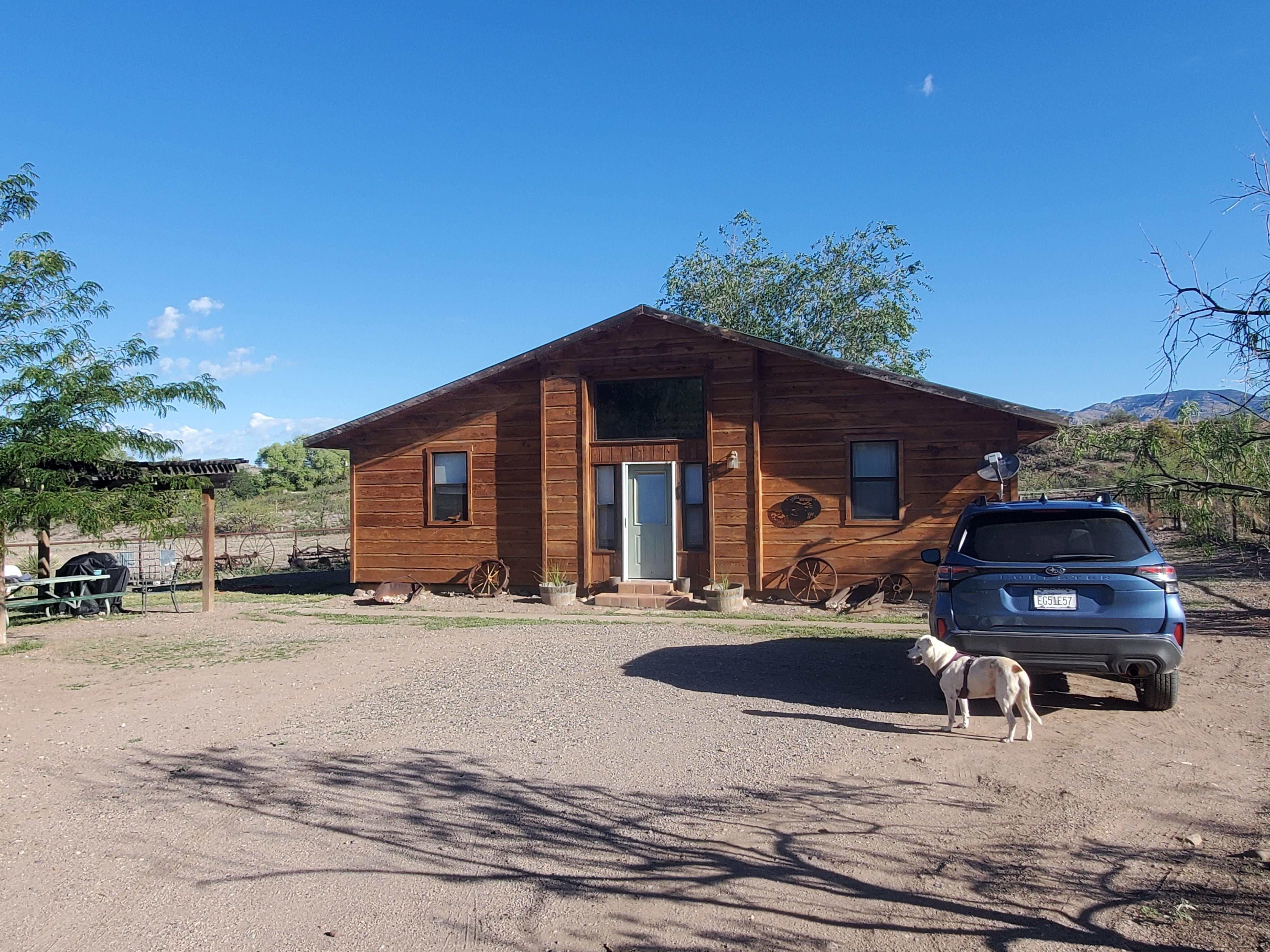 Gatehouse and parking area.  Shaded sitting area and fire pit are off to the left.