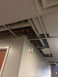 Missing ceiling tiles in the hallway