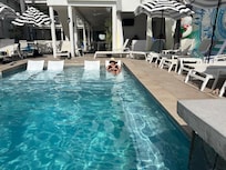 Pool with loungers in water