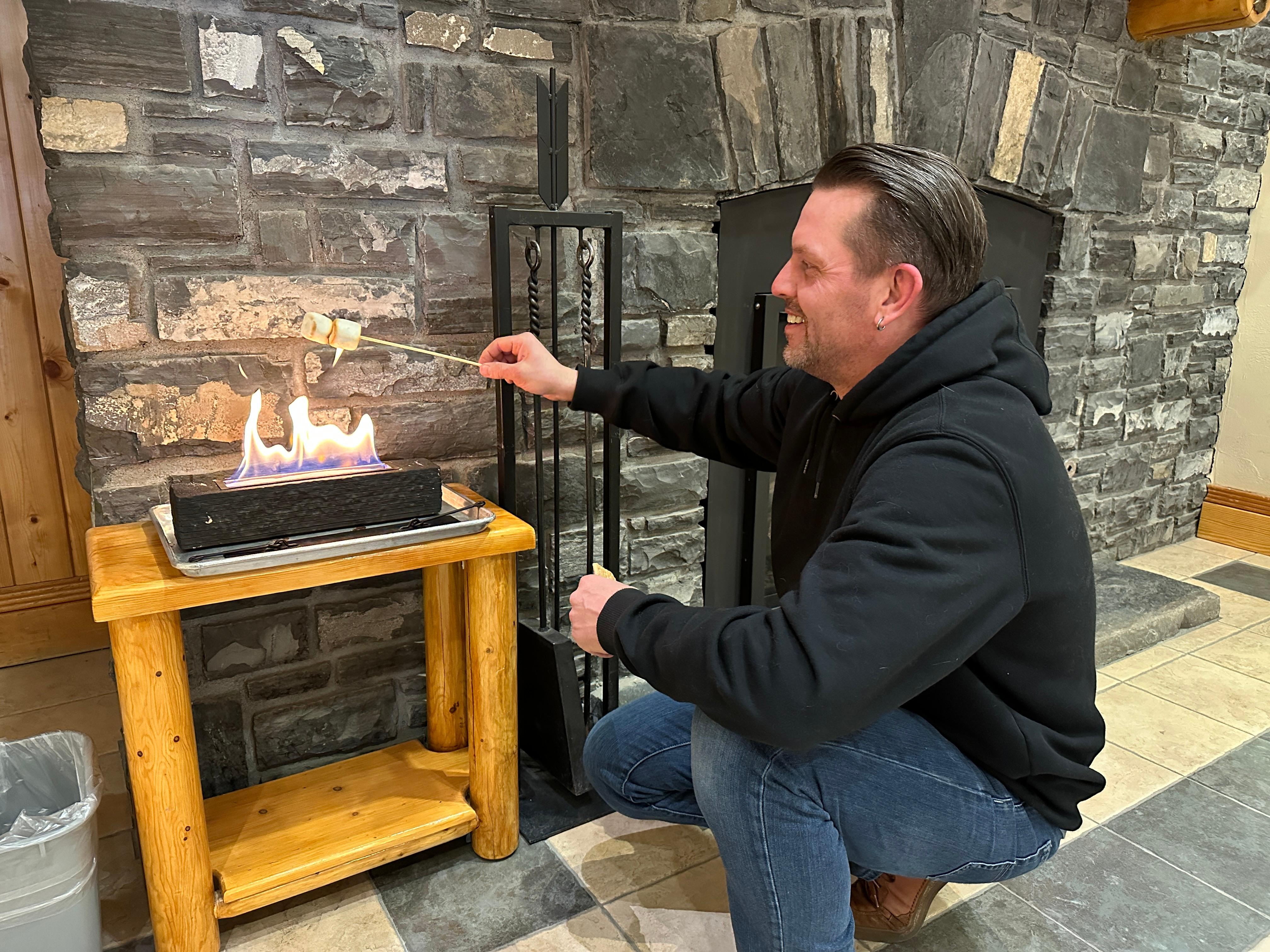 Toasting a marshmallow in the lobby.