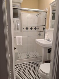 Truly appreciated the walk in shower. Small but functional bathroom. Charming decor!