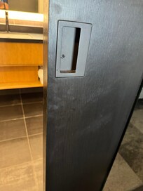 Dirty greasy hand prints on door to bathroom.