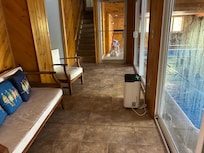 Hallway between the pool and downstairs bedroom. The bedroom has a queen bed, a pull out sofa, tv, and a half bath