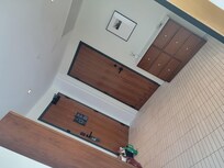 A view looking into the foyer entrance. Beautiful wood armoire to the left, door to adjoining room (if needed) to the right, entry door at center/left.