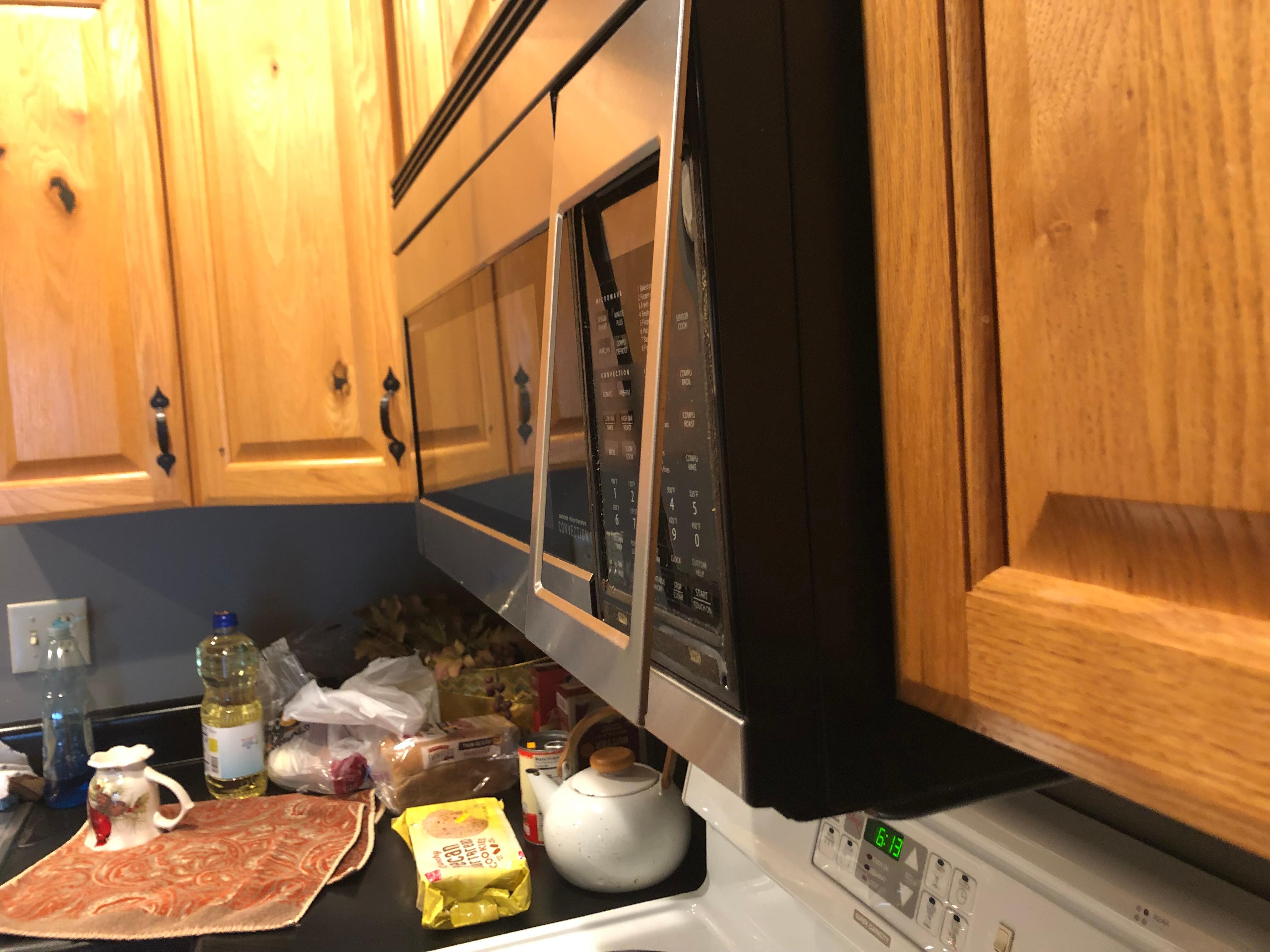 Plate hanging off microwave 