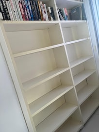 Bedroom with great closet space and great selection of books.