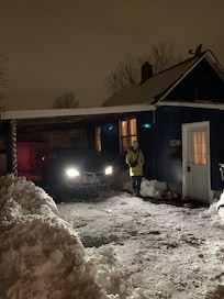 My fiancé next to the house with the carport.
