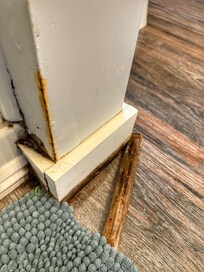 Damage in bathroom with mold and staining on the wall