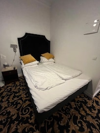 Bed against wall made room feel cramped