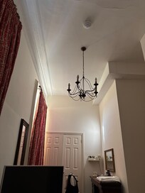 The room, whilst functional has ended up rather awkward in shape with the once elegant plaster ceiling decor simply sub divided