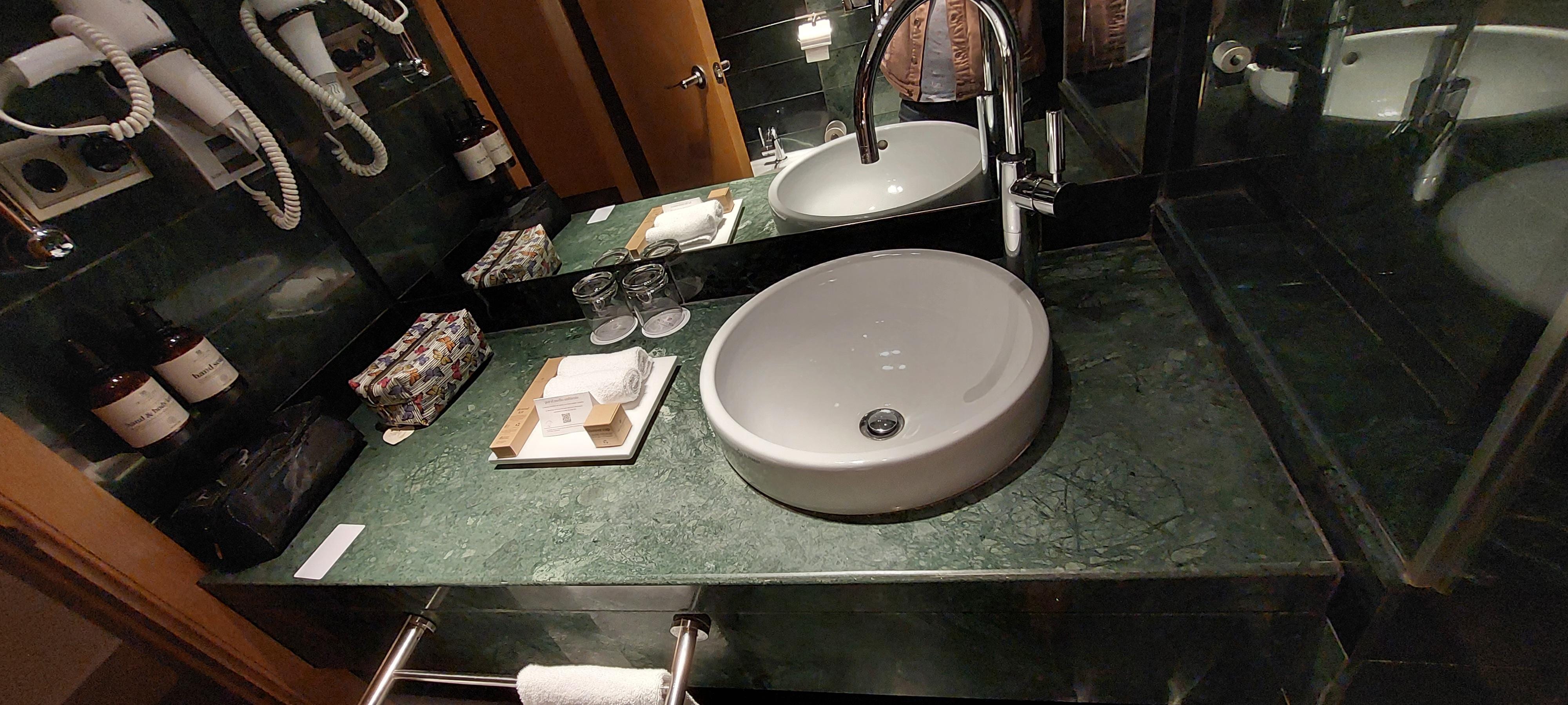 Wash basin, hairdryer with dental kit & shower cap.