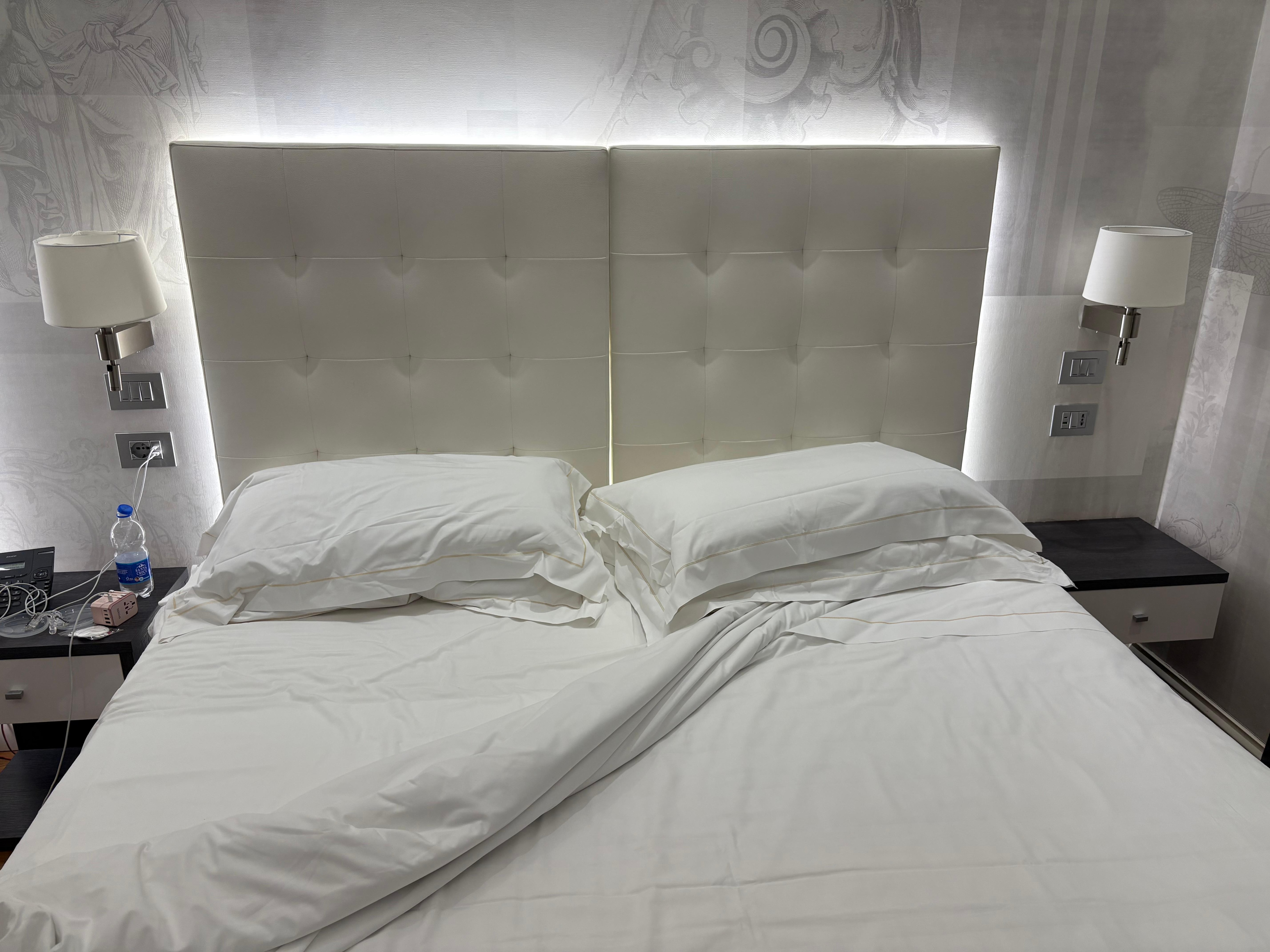 Comfortable bed with cool lighting around the headboard
