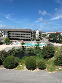 Pool area and small ocean view thru building