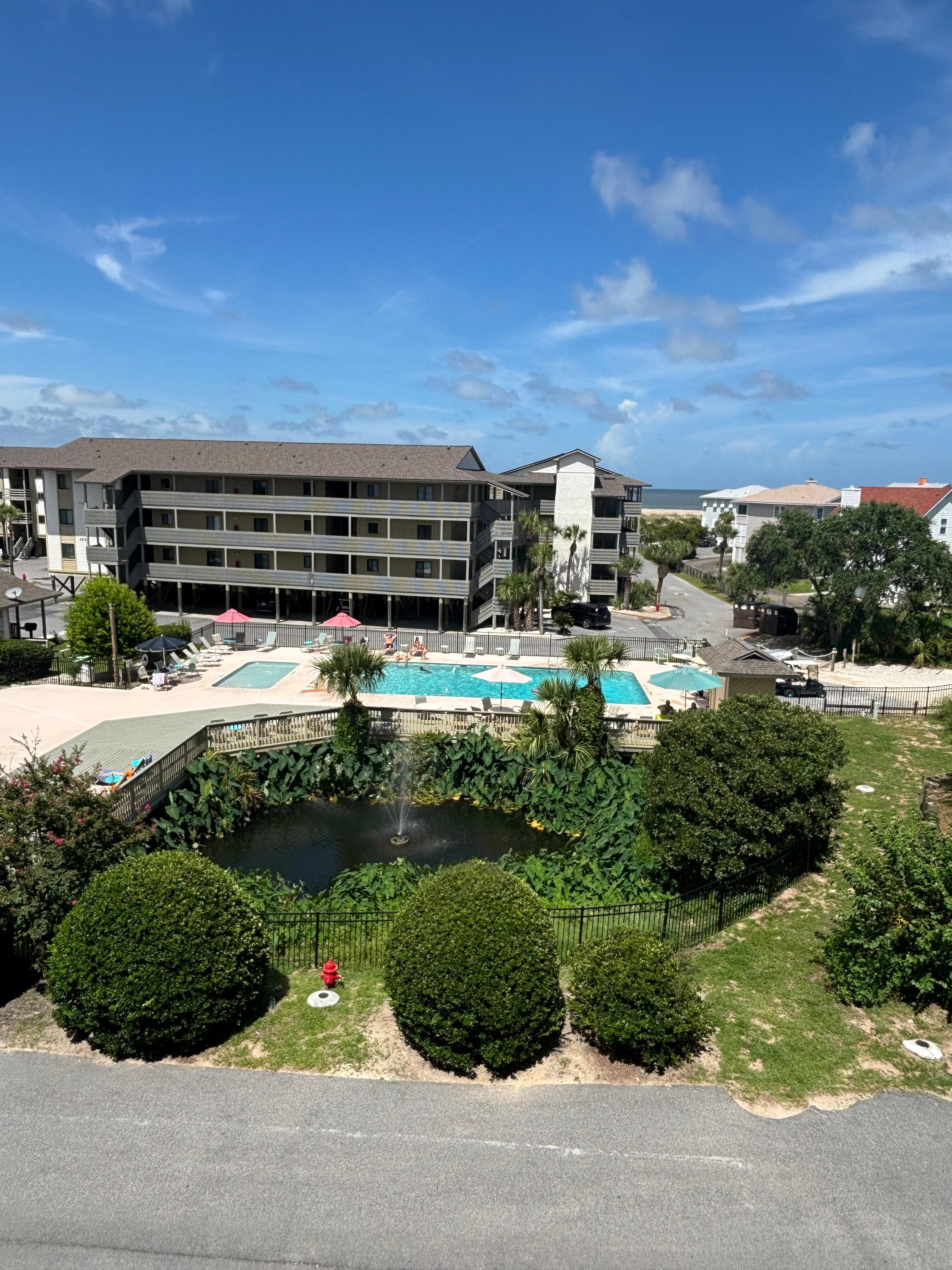 Pool area and small ocean view thru building