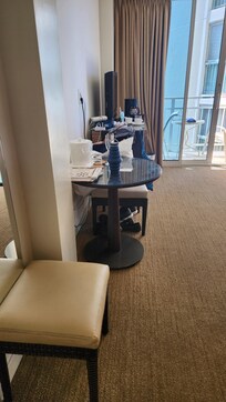 Said table and chairs provided. On chair and stool. Not a work place or to share a meal.