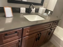 Bathroom (has lighted vanity mirror next to big mirror)