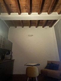 The chic, high-ceilings and exposed beams of the apartment