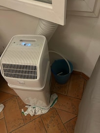 The one bedroom has air, but the rest of the apartment has this one air conditioner with the hot air tube going through the open window, there is a small bucket where the condensation goes into that overflows and empties into the floor every 4 hours
