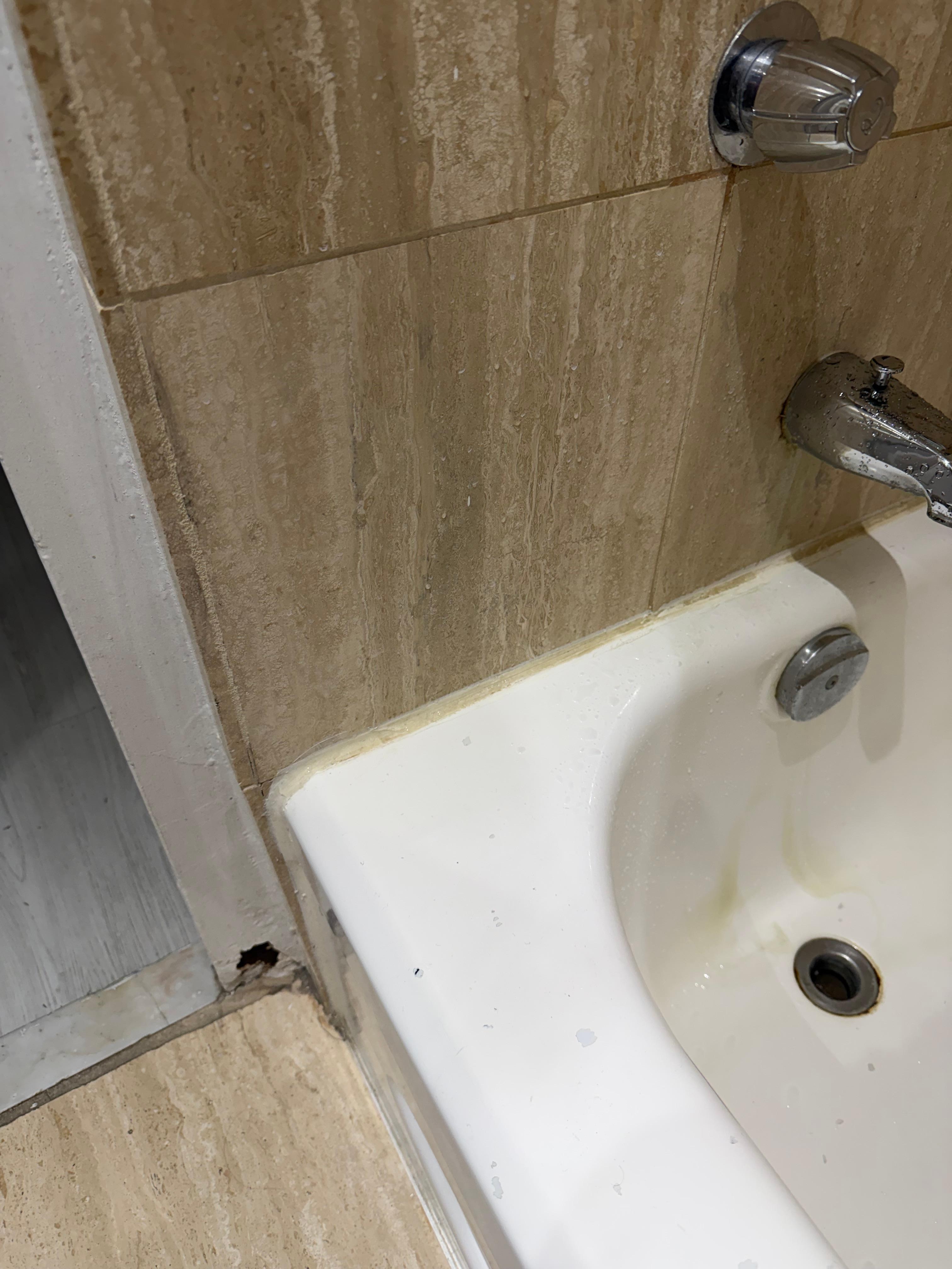 Mold on the door frame and staining in the tub. 