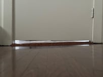 The door shows the gap on one side is more than the other due to the slant in the floor.