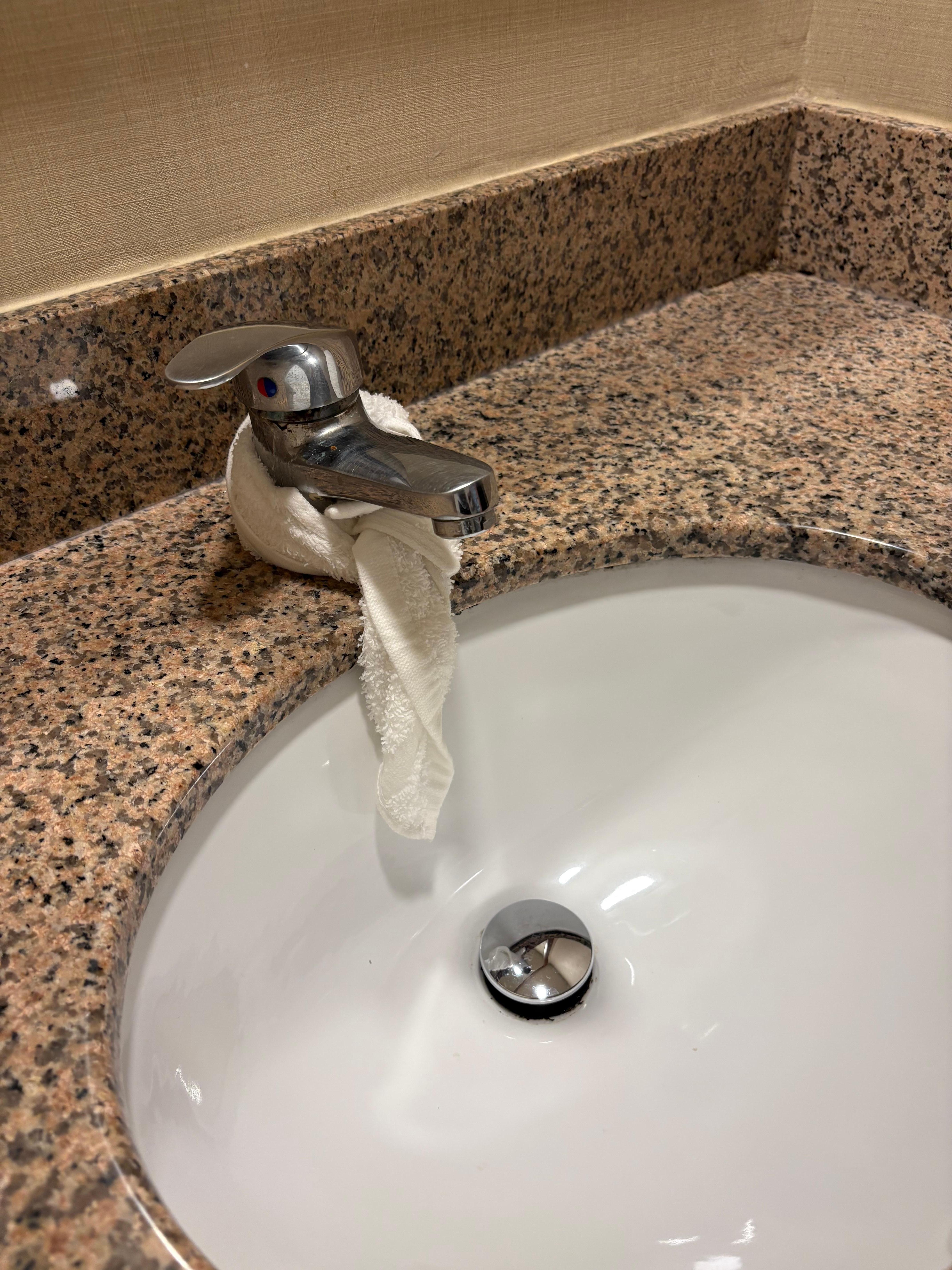 Bathroom sink leaking with rag to direct water in sink