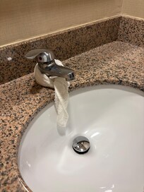 Bathroom sink leaking with rag to direct water in sink