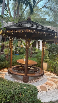 A place to rest in the middle of the Garden , on the way to the restaurant , pool and bar