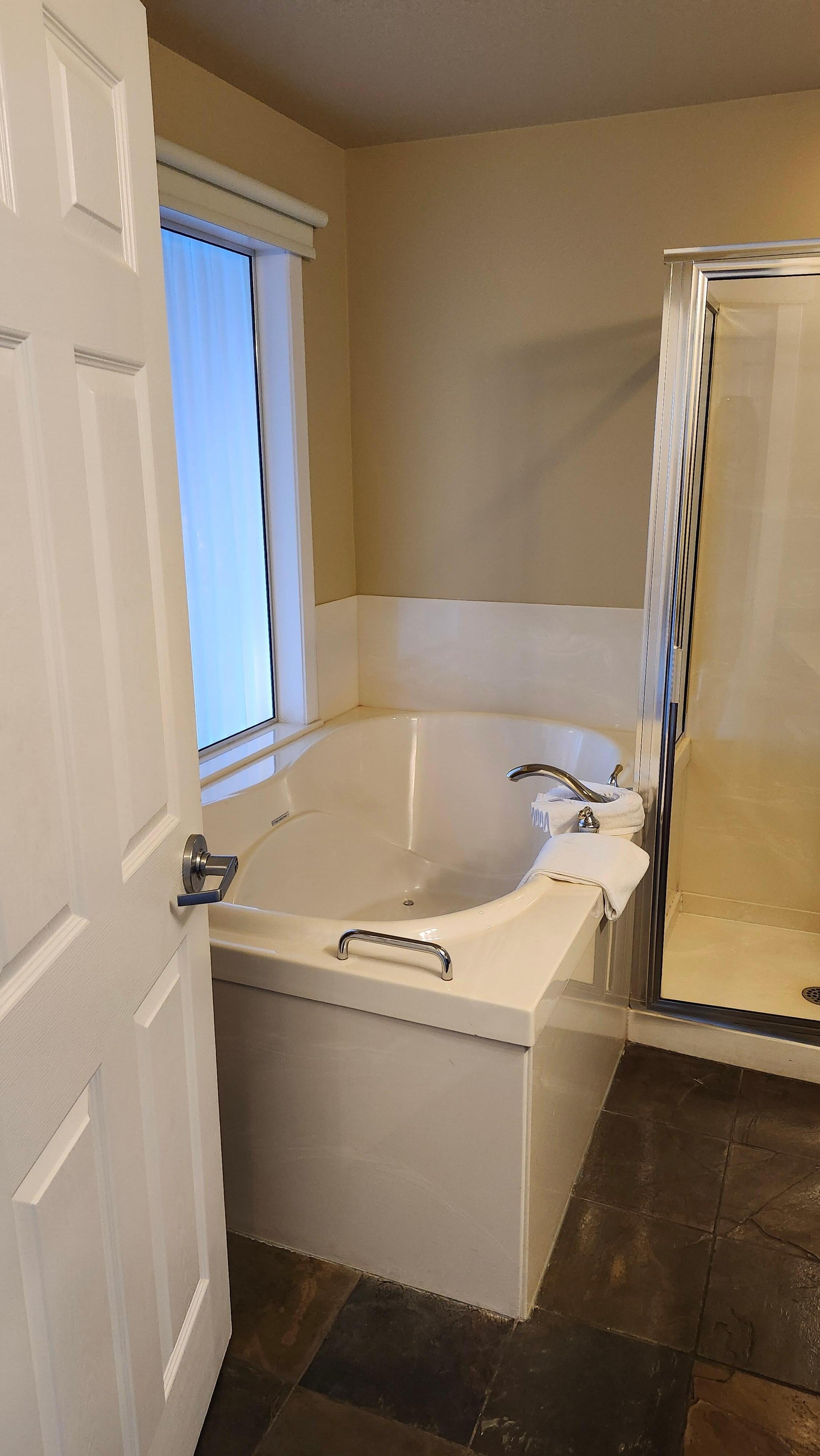 Lovely and clean bathroom with window/curtains to hotel room