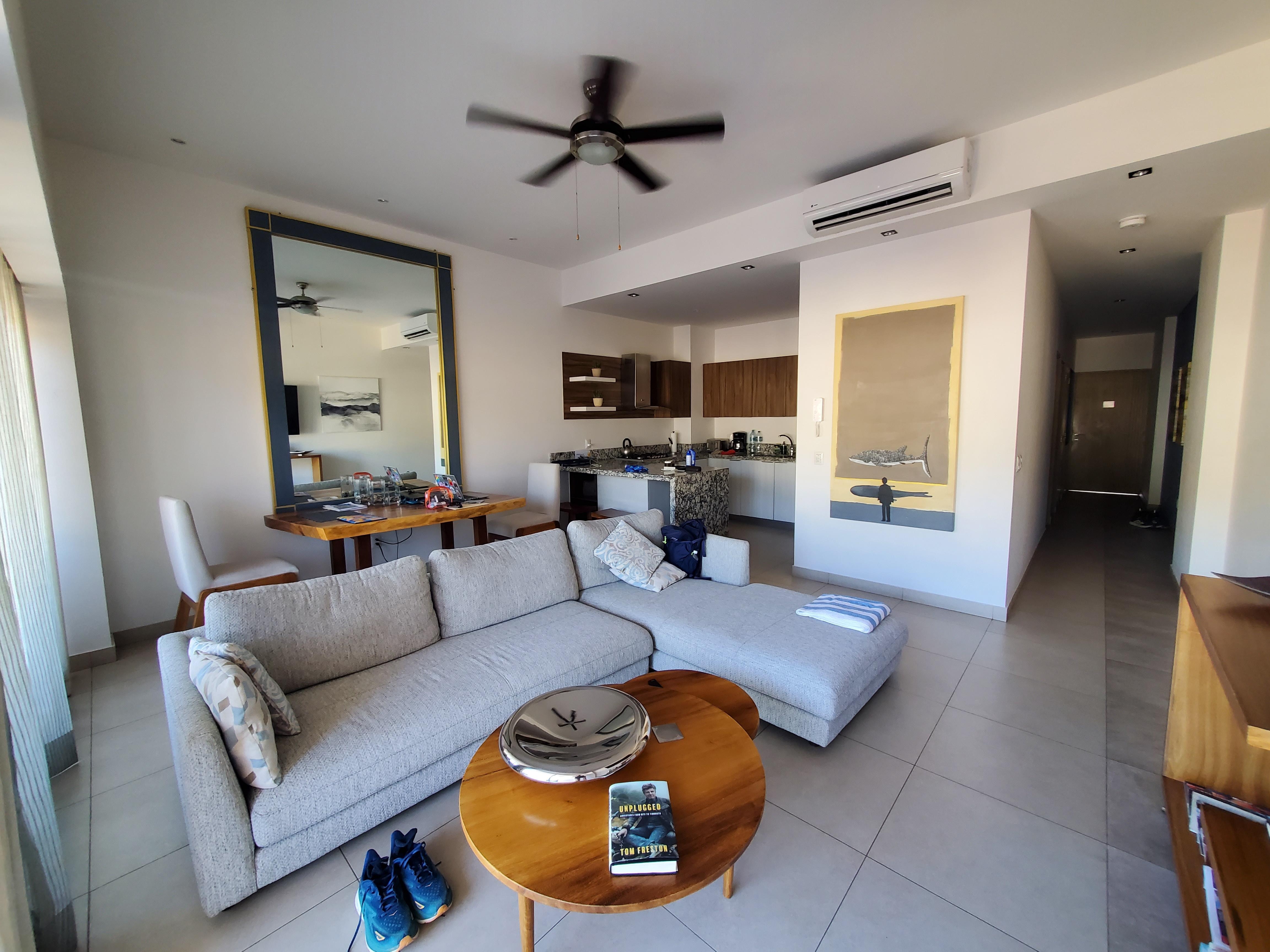 Main living and dining area. Balcony is beyond the curtains on the left with view of the mountains