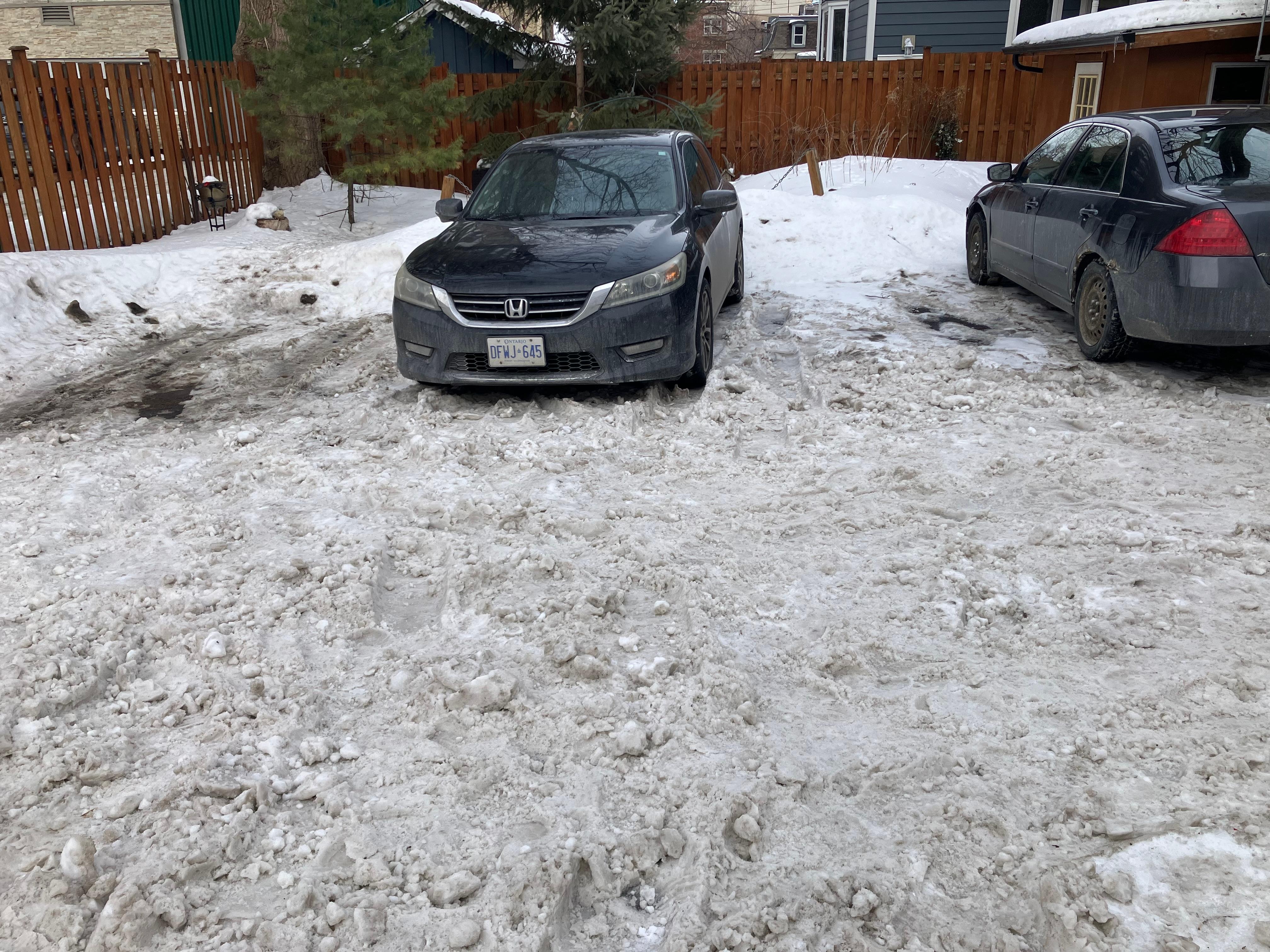 The space between these cars is too narrow to park