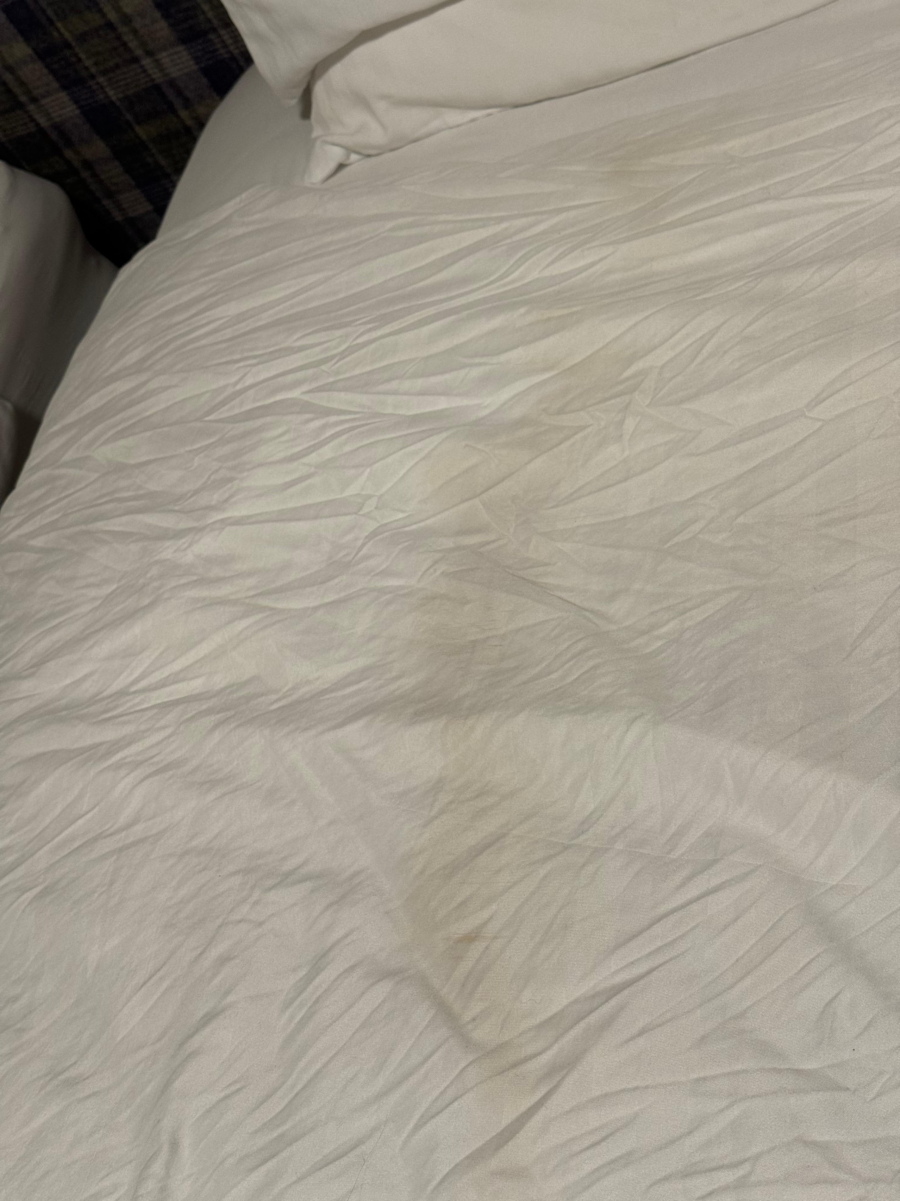 Badly marked and stained quilt cover right down the centre.