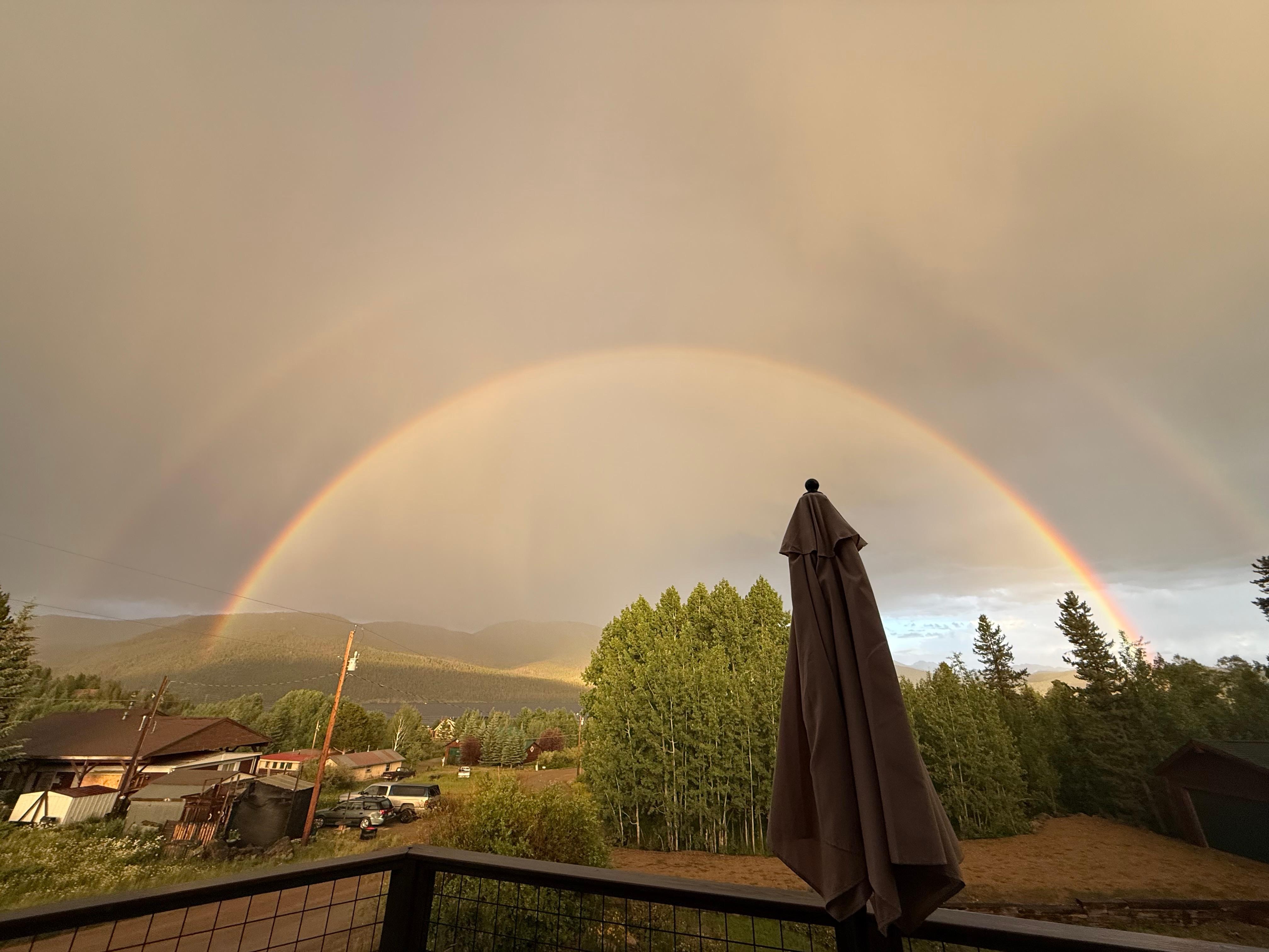 Double rainbow over the mountain and lake