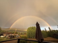Double rainbow over the mountain and lake