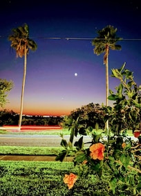 Having a glass of vine watching the sunset from outdoor covered patio.