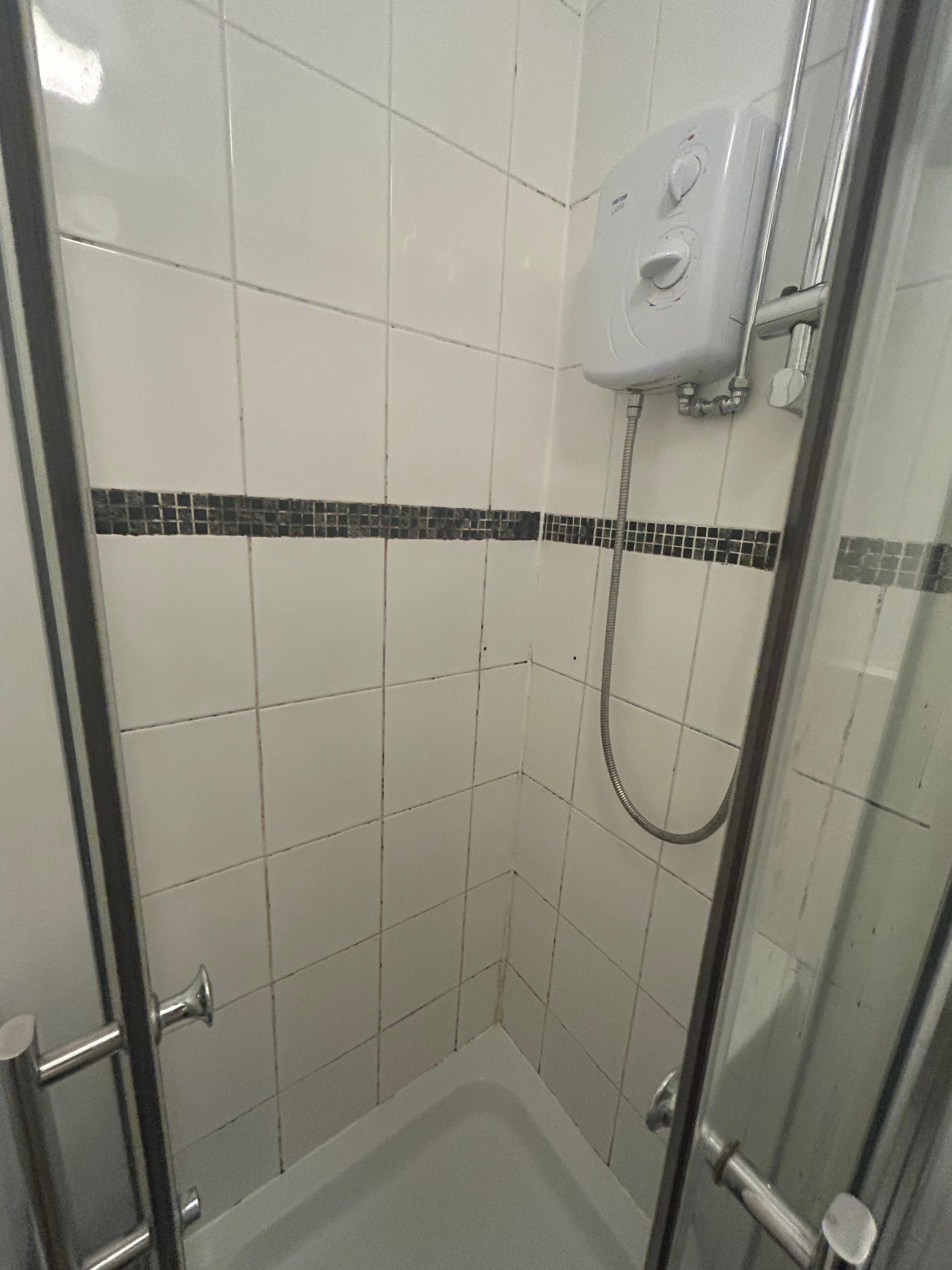 Mouldy grout and really small shower that didn’t work properly 