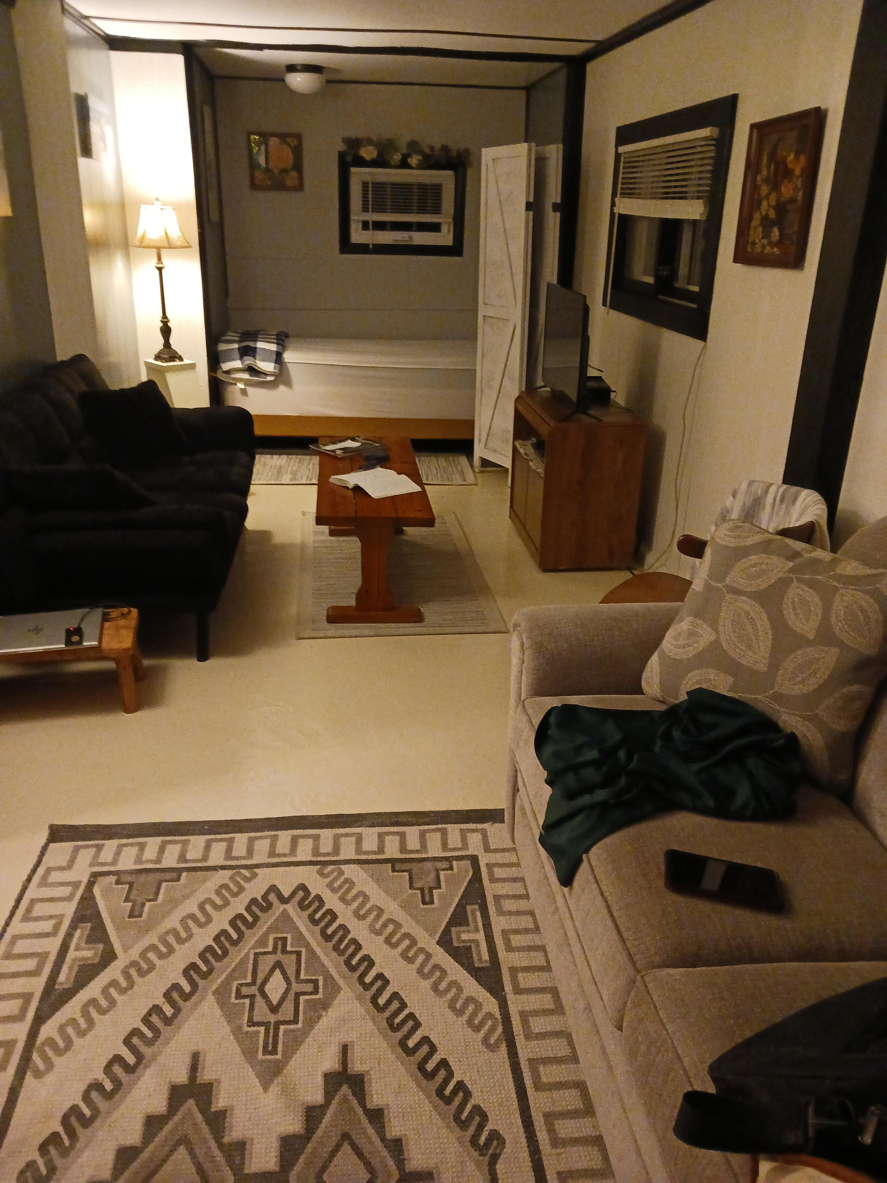 Living area- Back is a single bed. There is a tv and some boardgames. Front couch is a sofasleeper- full sized.
Not shown because I didn't take a picture- Partially enclosed outdoor seating area and fire pit with wood.